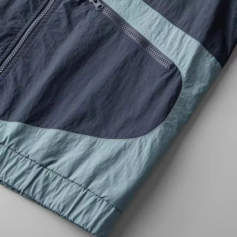 Everyday men's lightweight Apex windbreaker jacket in blue/yellow. Water-resistant outerwear for spring & fall.