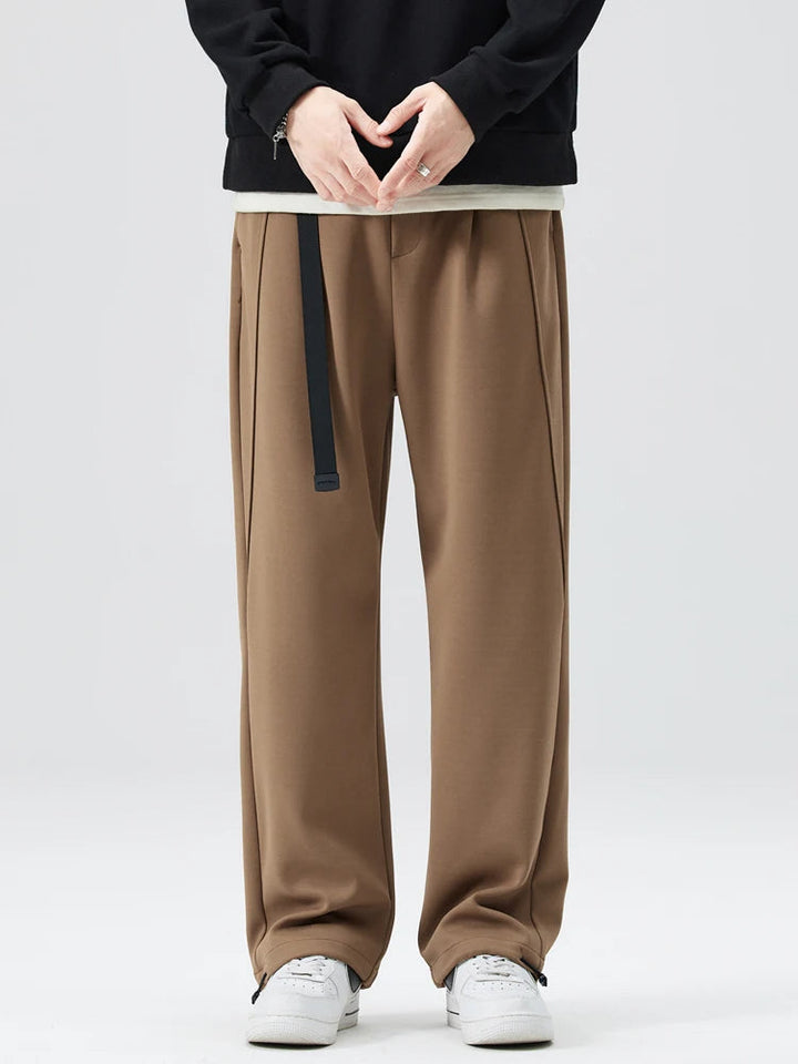 Close-up of men's Atlas wide-leg trousers fabric texture & drawstring waist for comfort.