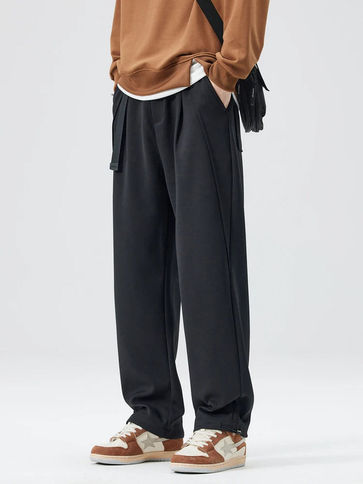 Man wearing casual Atlas wide-leg trousers, relaxed fit, stylish & comfortable for daily activities.