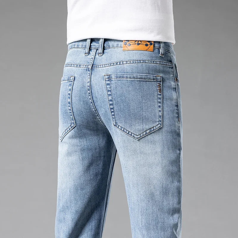 Stylish men's Aven white slim-fit stretch jeans. Comfortable, modern denim for casual wear.