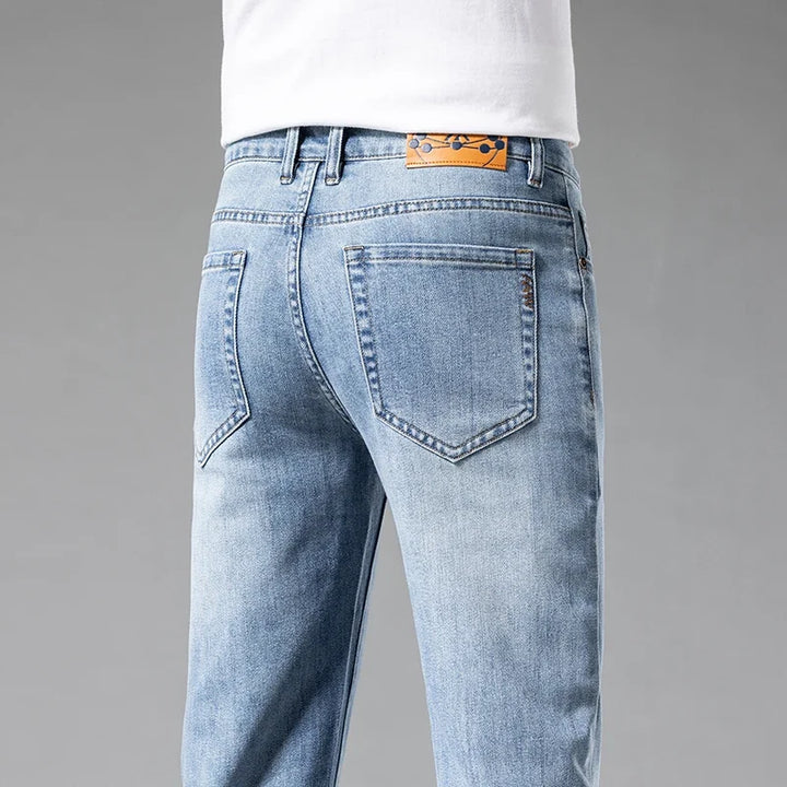 Stylish men's Aven white slim-fit stretch jeans. Comfortable, modern denim for casual wear.