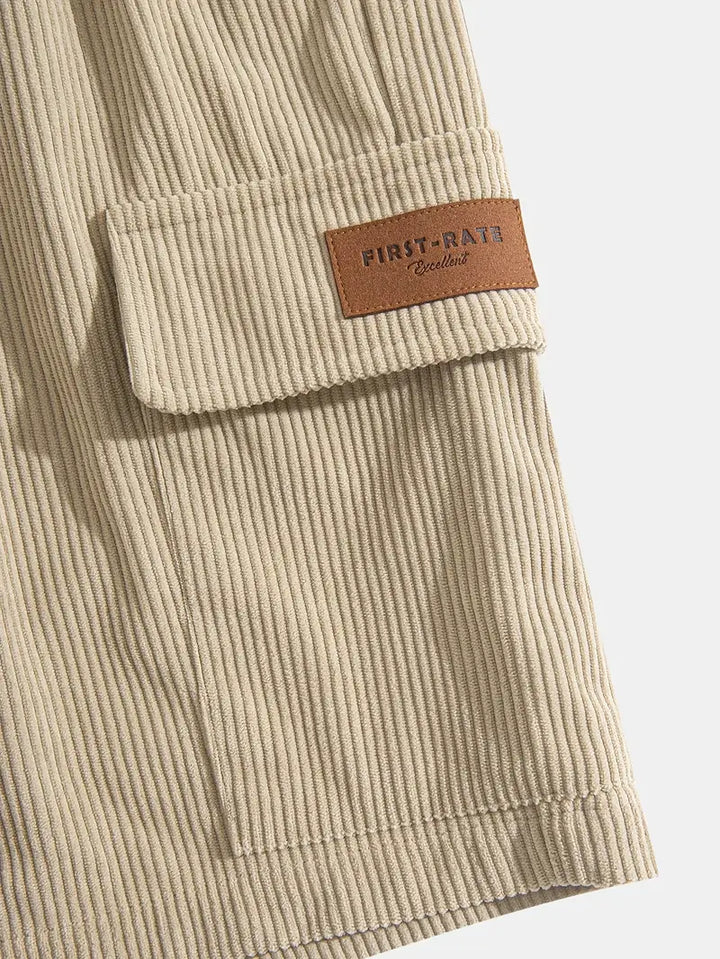 Close-up of men's beige corduroy cargo trousers, highlighting fabric and pocket detail