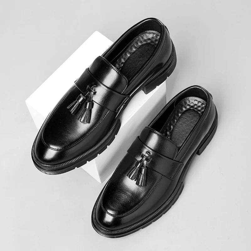 Side view of polished men's Belmont tassel loafers, showcasing classic design, tassels & quality construction.