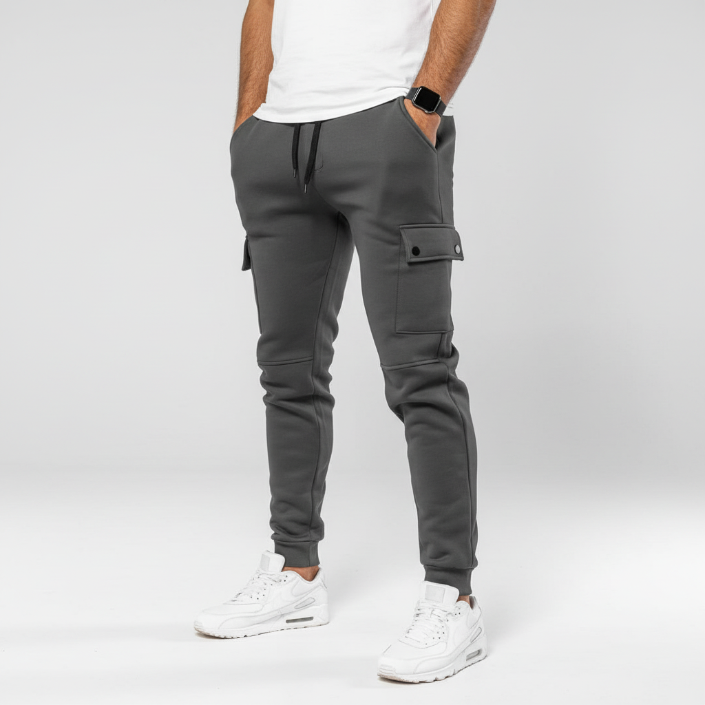 Stylish dark grey men's cropped joggers featuring practical pocket. Ideal for casual wear or workout.