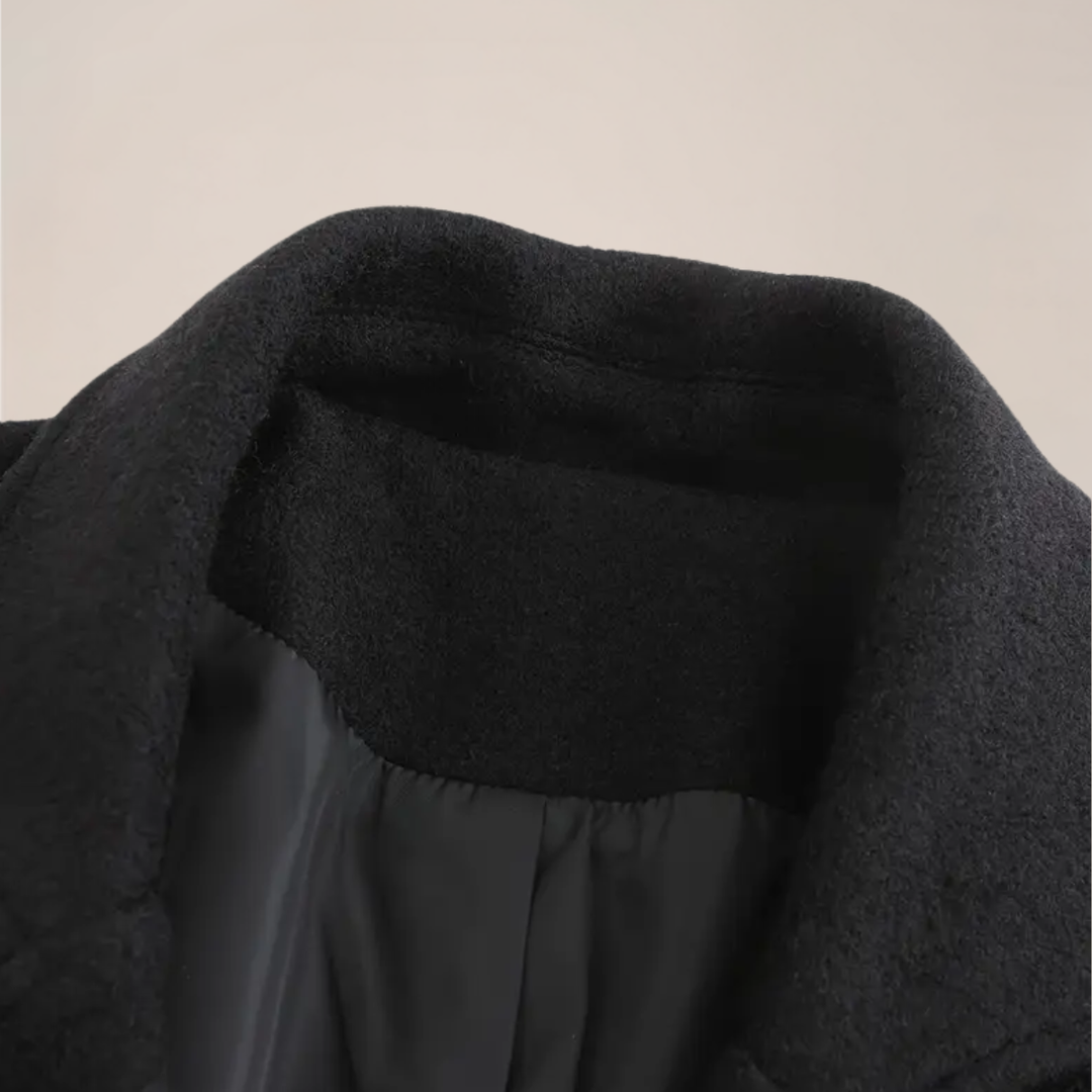 Back view of men's elegant black double-breasted overcoat. Stylish long winter coat, essential outerwear for men's formal fashion.