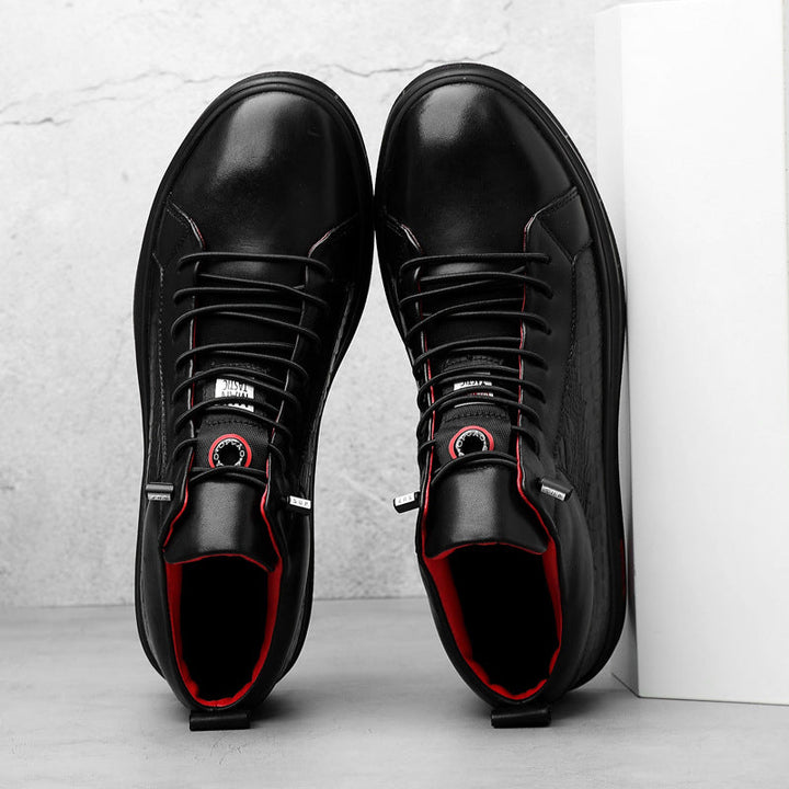 Stylish men's black high-top footwear, featuring bold red accents, great for a modern street style.