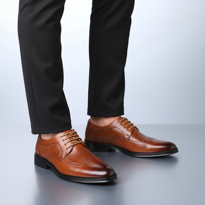 Pair of men's elegant brown Italian leather pointed-toe dress shoes, essential for sophisticated men's fashion