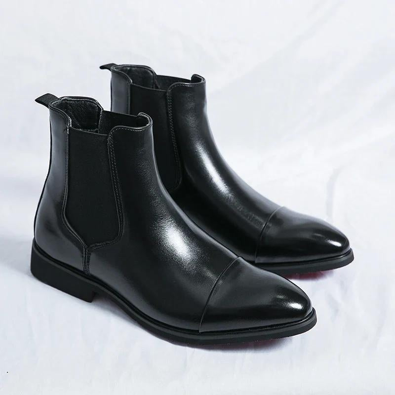 Classic men's Chelsea ankle boots, slip-on comfort, featuring a unique red outsole. Versatile footwear.