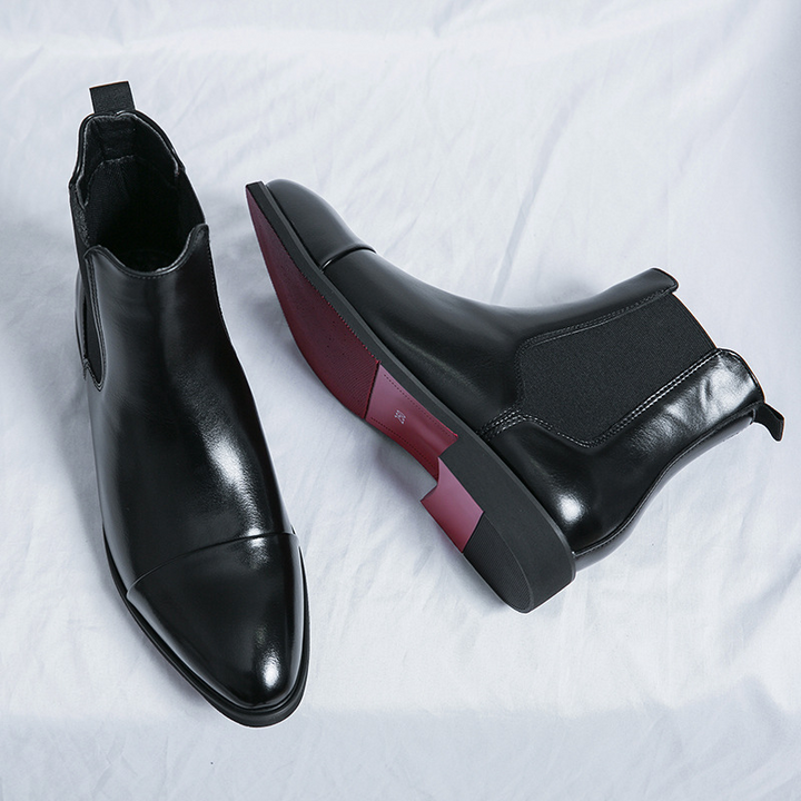 Stylish formal men's boots: black Chelsea with elastic side panels and eye-catching red sole detail.