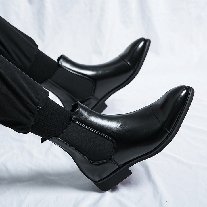 Comfortable men's slip-on Chelsea boots in black, perfect for both casual and dress occasions. Red sole.