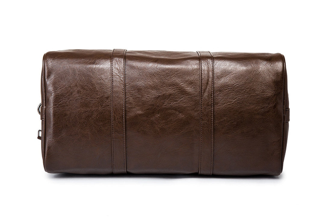 Close-up of the textured leather on a men's black travel duffel bag, highlighting material quality