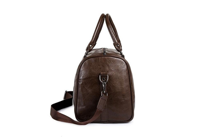 Men's black leather weekender bag standing upright, displaying its classic design and robust construction
