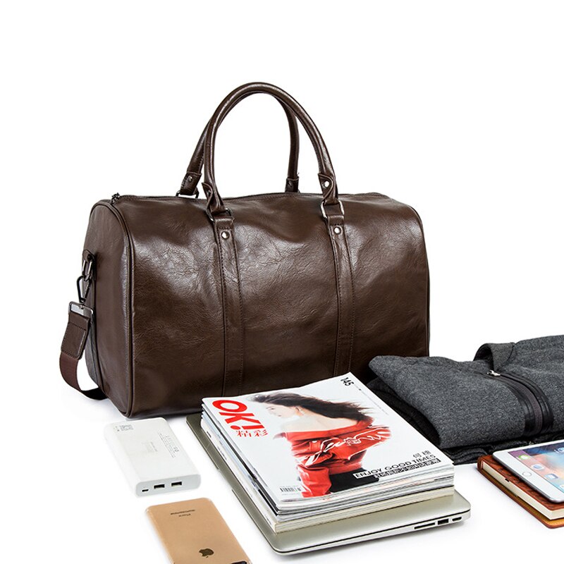 Detail of the hardware on a men's brown leather travel duffel, showing high-quality zippers and buckles