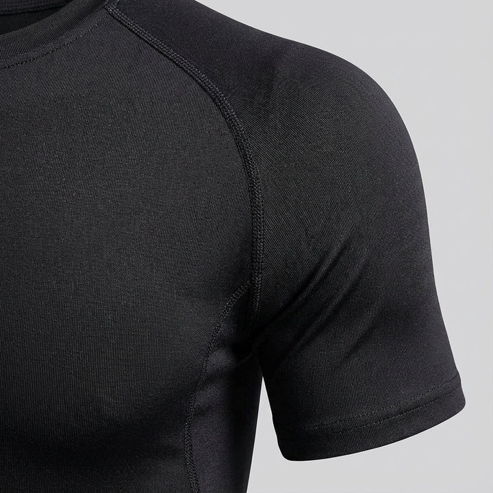 Man wearing long sleeve compression shirt, demonstrating flexibility for sports apparel