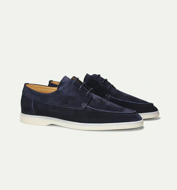 Close-up of men's black leather lace-up loafers, showcasing intricate stitching and quality.