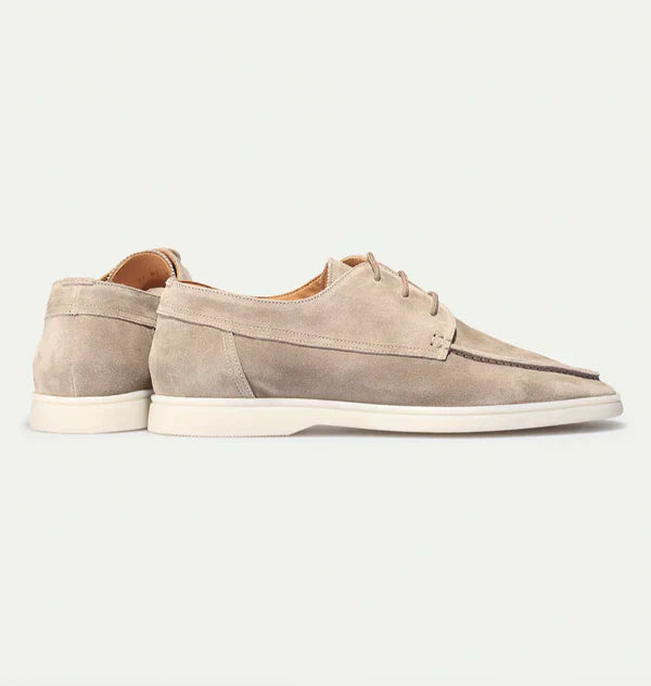 High-angle view of men's black leather lace-up loafers, classic formal footwear design.