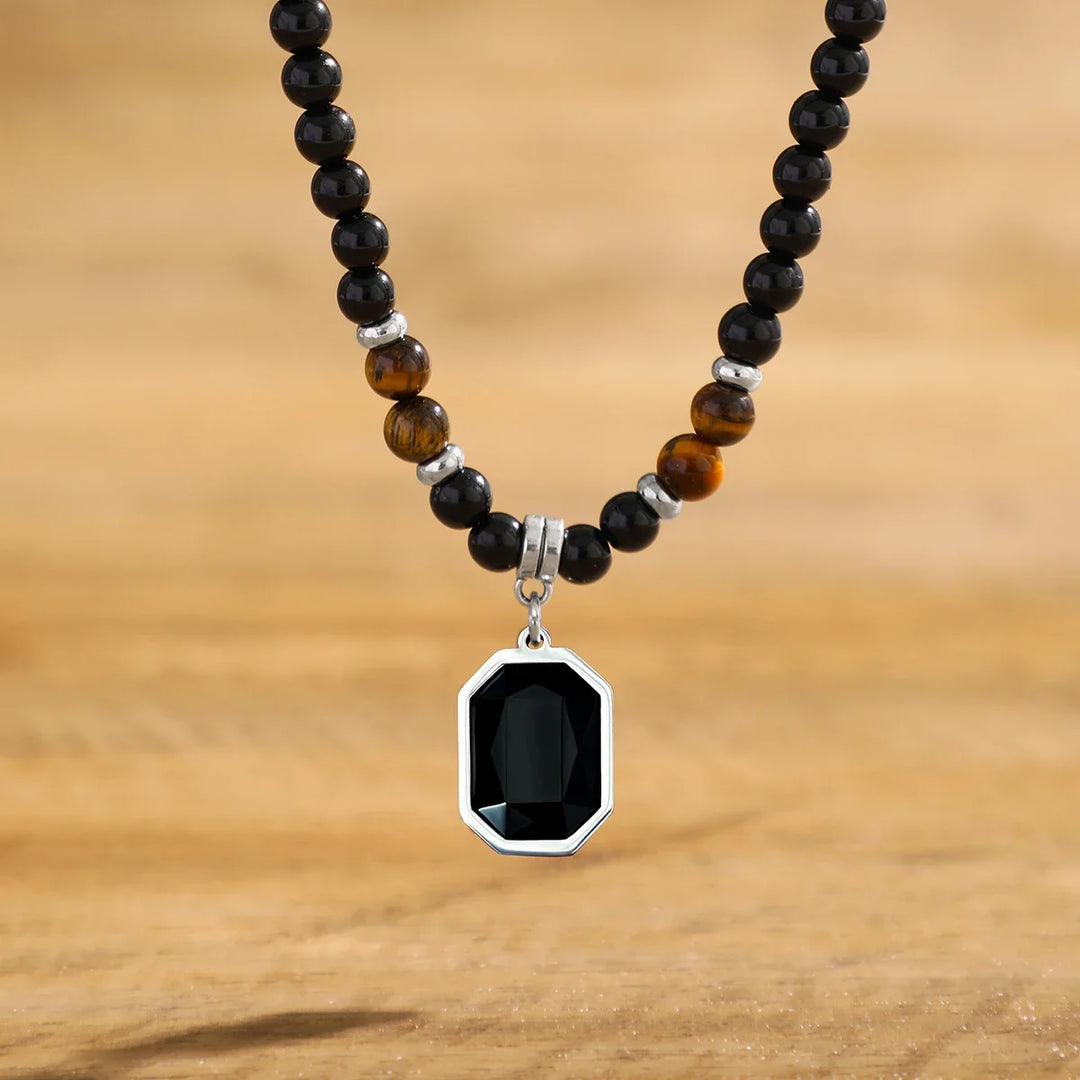 Close-up of a men's black onyx beaded necklace featuring natural gemstone beads, men's fashion accessory.