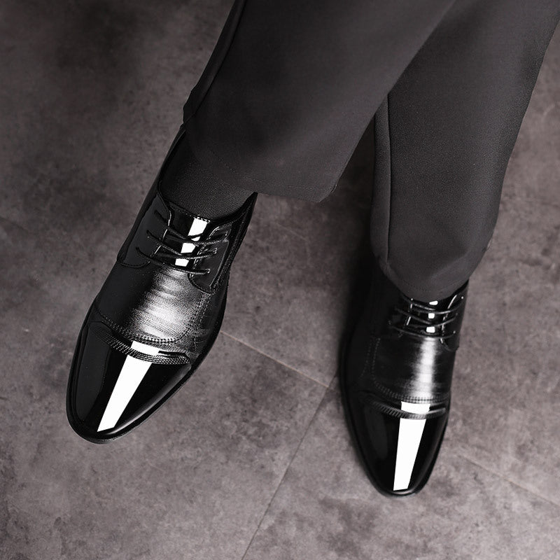 Close-up of laces on elegant men's black patent oxford dress shoes, a detail of classic formal mens footwear.