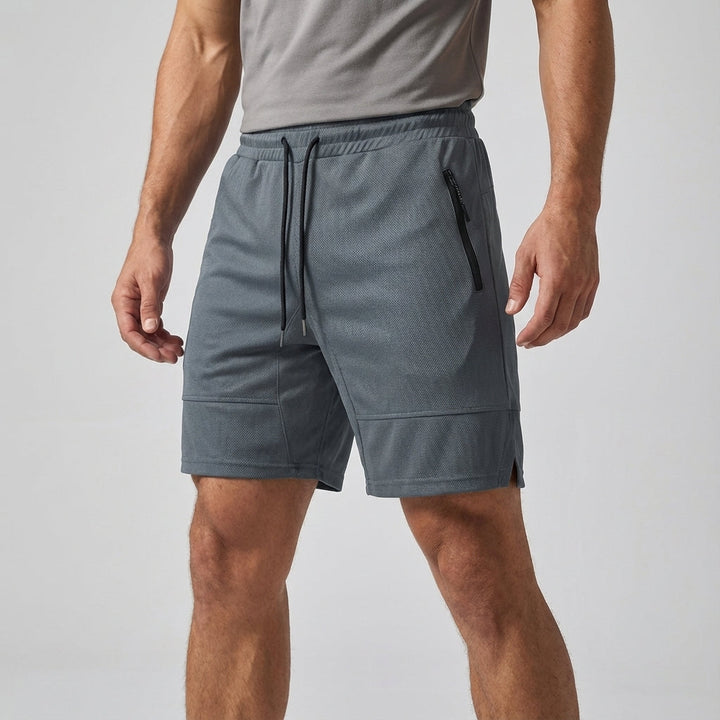 Black men's gym shorts, performance-oriented with a secure zipper pocket, essential sportswear for active men.