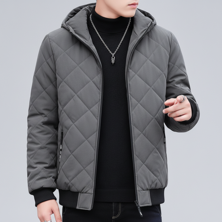 Full-length view of a men's black quilted winter jacket with hood, ready for cold protection.