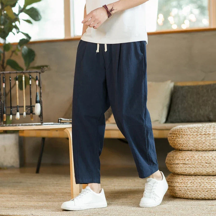 Olive men's relaxed fit drawstring pants, perfect for casual everyday wear. Comfortable and fashionable men's bottoms.