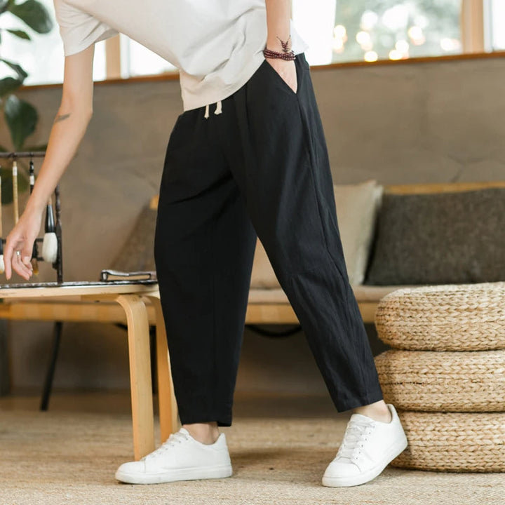 Classic black relaxed fit drawstring pants for men. Comfortable casual bottoms, ideal for everyday style.