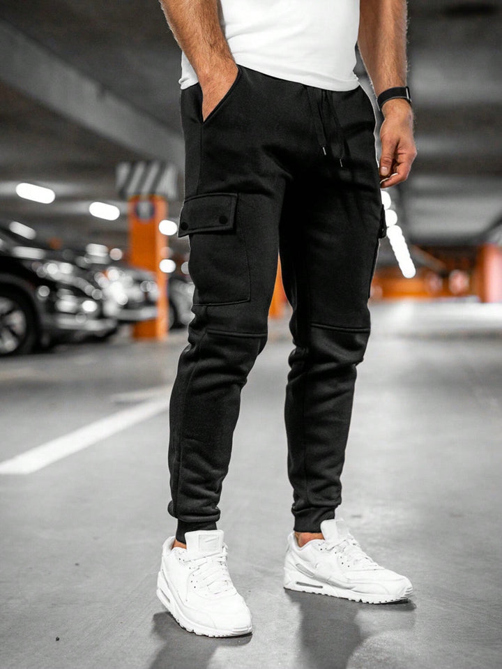 Close-up of comfortable fabric and detailing on men's slim-fit streetwear jogger pants.
