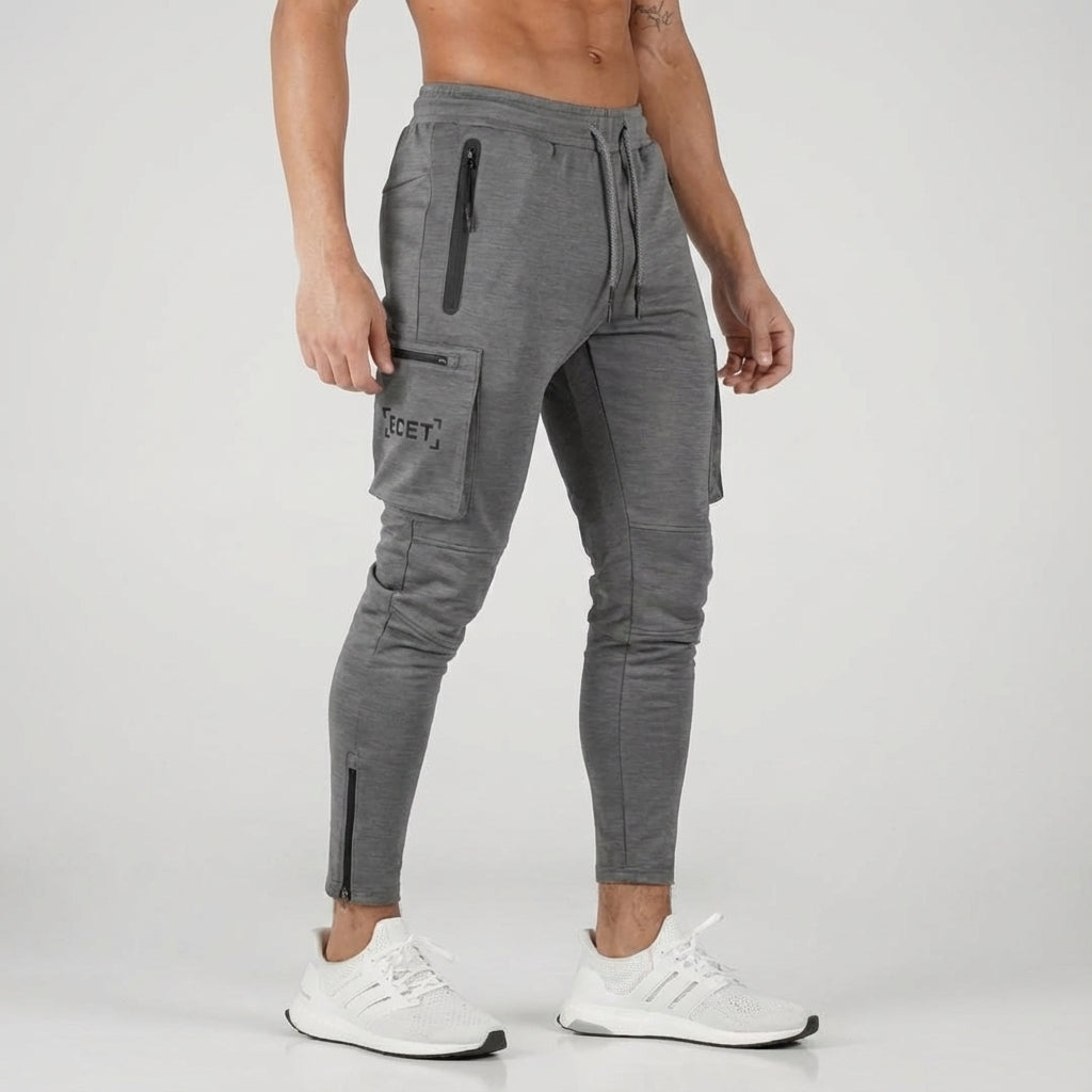 Men's tapered track pants, black, designed for comfort and performance with secure zip pockets