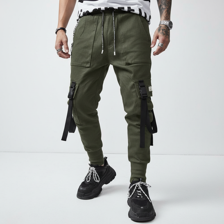 Stylish men's cuffed harem pants in a dark color, perfect for urban streetwear with practical pockets