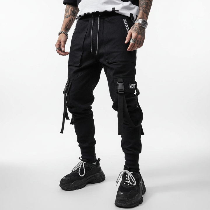 Full shot of a man wearing versatile cotton blend harem pants with cuffs, ideal for casual urban fashion