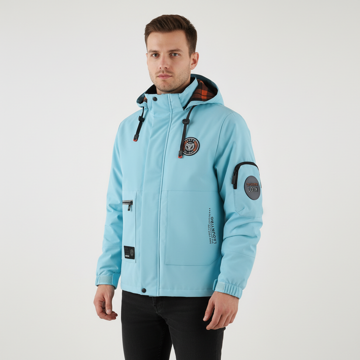 Side view of a man in an orange waterproof hooded jacket for men, perfect for active outdoors use