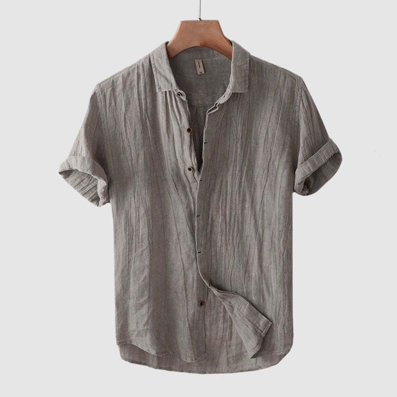 Summer-ready men's short sleeve shirt. Features a trendy crinkle texture and button-down style.