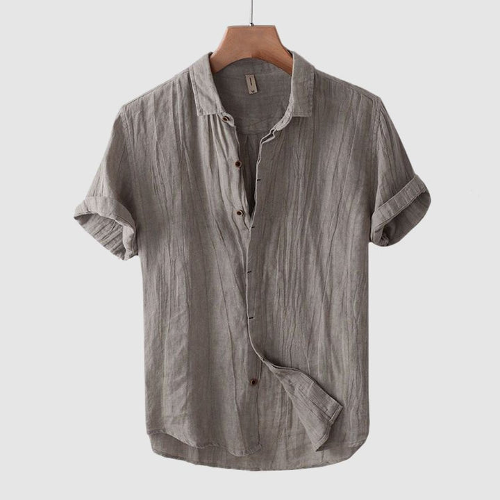 Summer-ready men's short sleeve shirt. Features a trendy crinkle texture and button-down style.