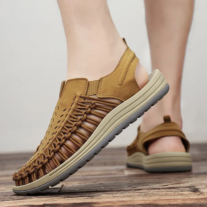 Close-up of men's braided open-toe sandals, highlighting intricate strap design & breathable comfort.