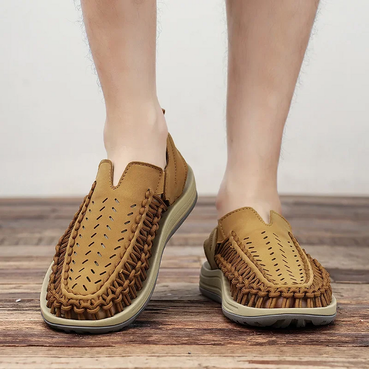 Men's comfort braided sandals walking on a trail, perfect for outdoor adventures & summer wear.