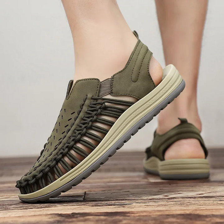 Men's lightweight braided travel sandals held in hand, ready for summer adventures & easy packing.