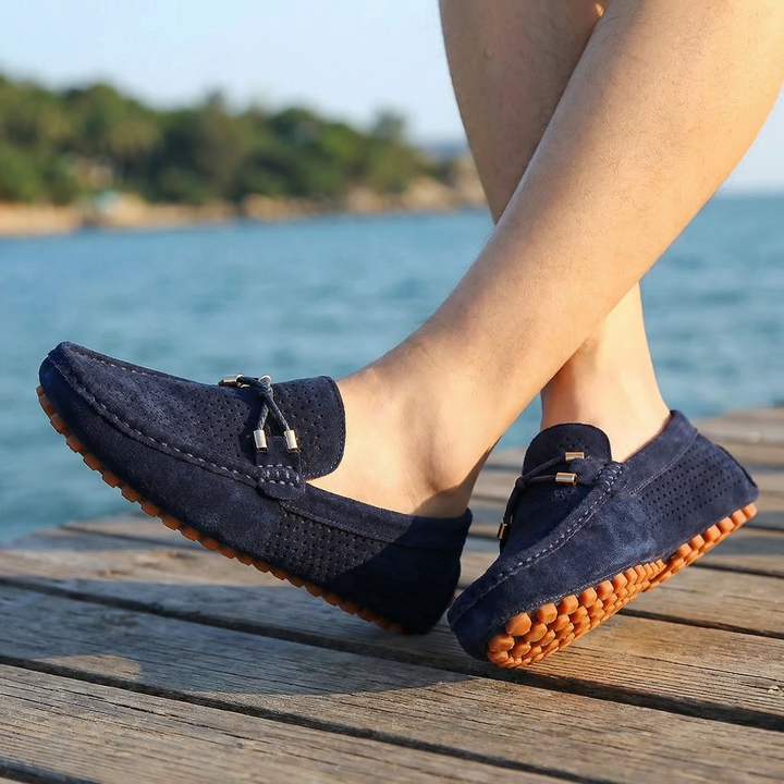 Stylish men's casual perforated leather loafers, breathable slip-on design for daily wear.