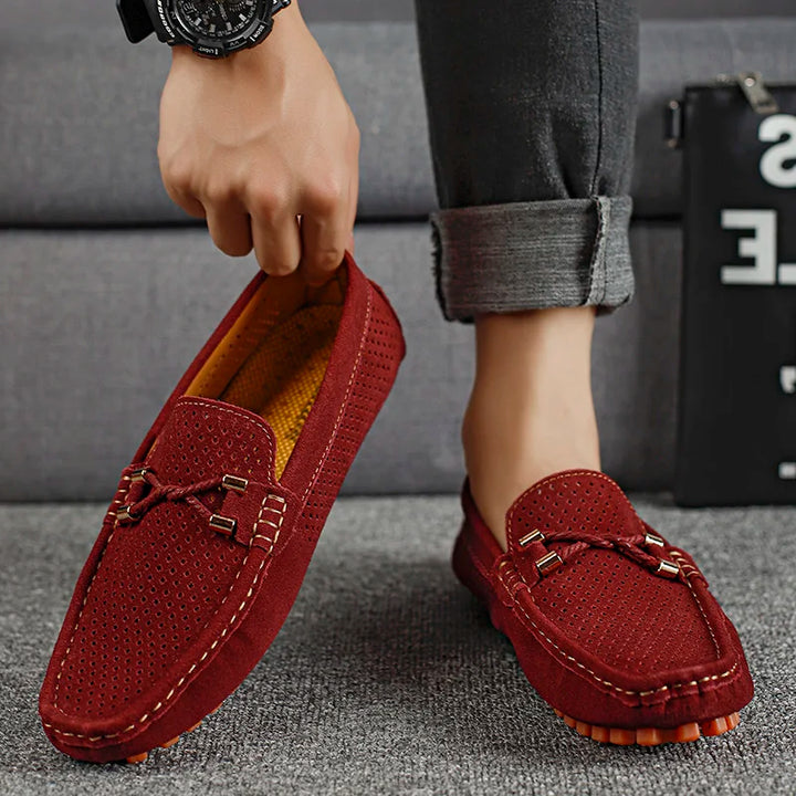 Premium men's leather slip-on shoes, perforated for breathability and walking comfort.