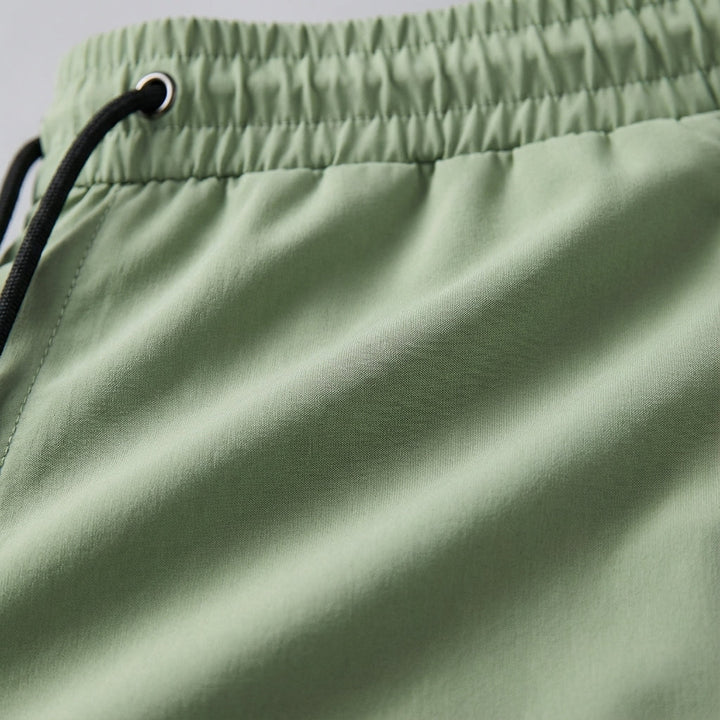 Breathable men's track pants with elastic waist, perfect for performance apparel.