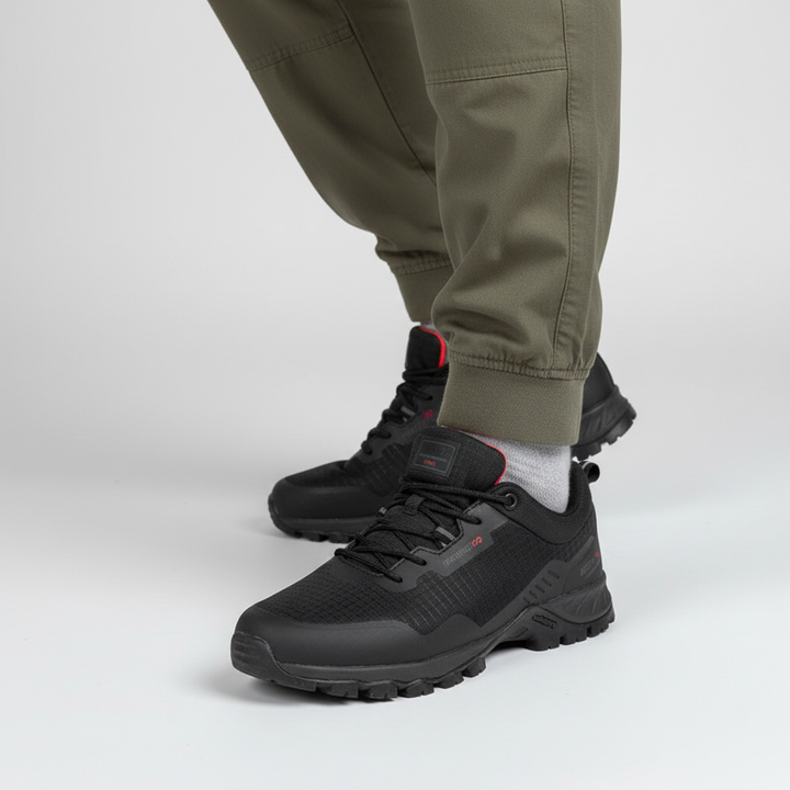 Side view of men's outdoor sneakers, black with white sole, emphasizing waterproof and breathable features