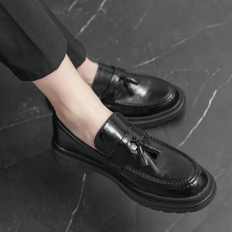 Lug sole and tassel detail on men's black Belmont Loafers, a blend of style and function.