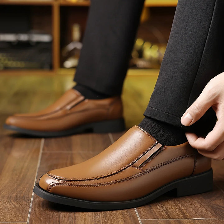 Close-up of men's premium leather Oxford loafers, offering comfortable slip-on style for dress or casual wear.