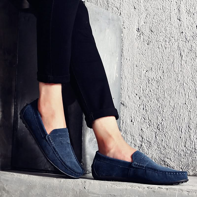 Men's navy slip-on shoes, offering dress loafer style with casual comfort for daily wear.