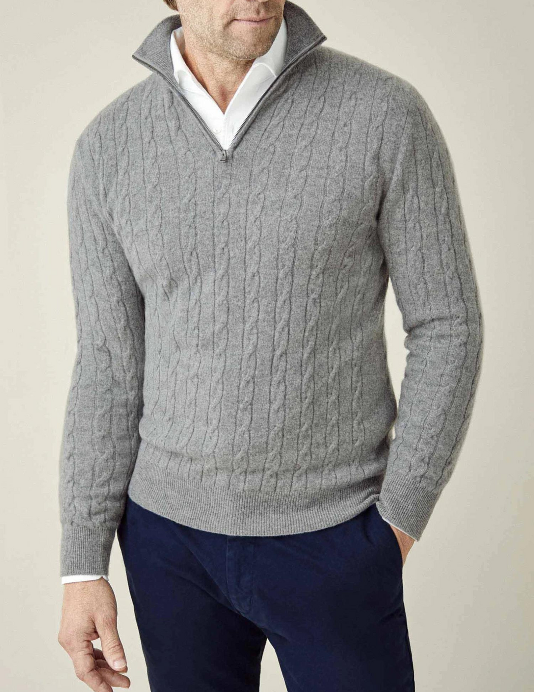Men's cable knit quarter-zip sweater styled for smart casual layering, ideal for colder days.