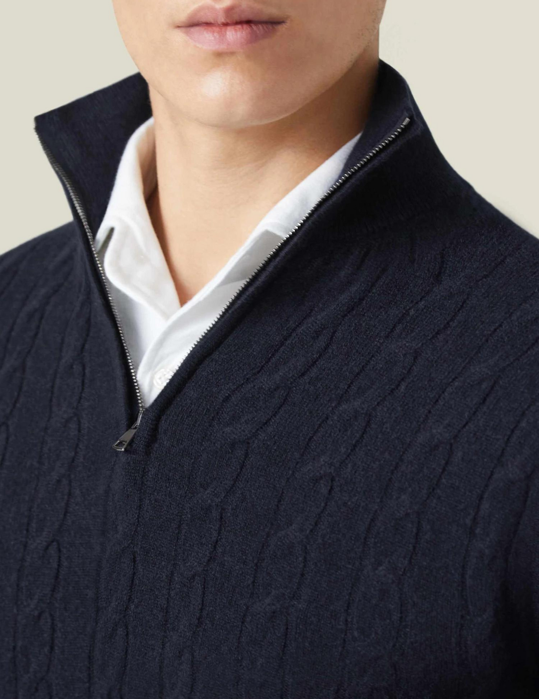 Layering-friendly men's cable knit quarter-zip sweater, offering comfort and timeless style.