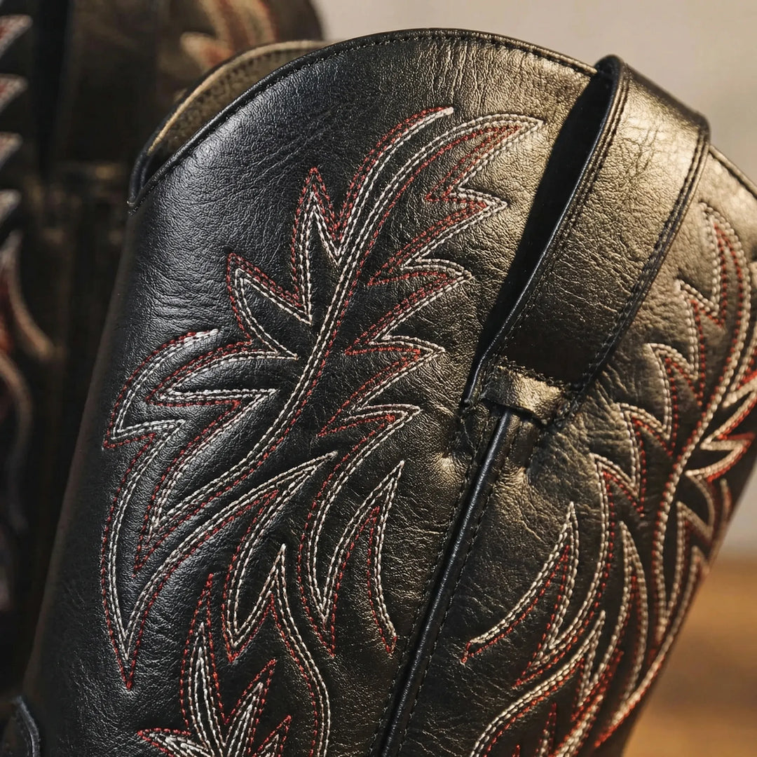 Men's rugged Western cowboy boots, calf-length design with detailed embroidery and practical block heel.