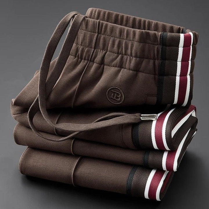 Men's Callahan elastic-waist pants with a modern spliced design, perfect for casual urban fashion.