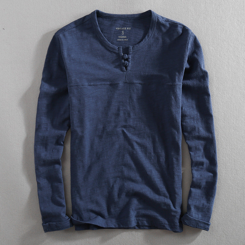 Stylish men's navy henley shirt. Versatile long-sleeve top for effortless casual comfort.