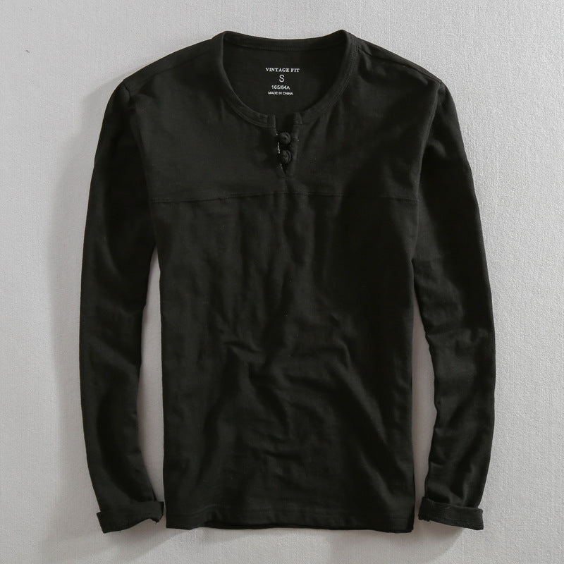 Versatile men's black henley shirt. Effortless long-sleeve top, perfect for casual or everyday wear.