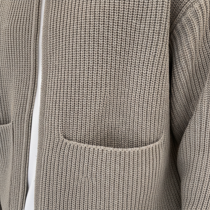 Stylish man wearing a modern gray knit cardigan sweater, perfect for fall fashion